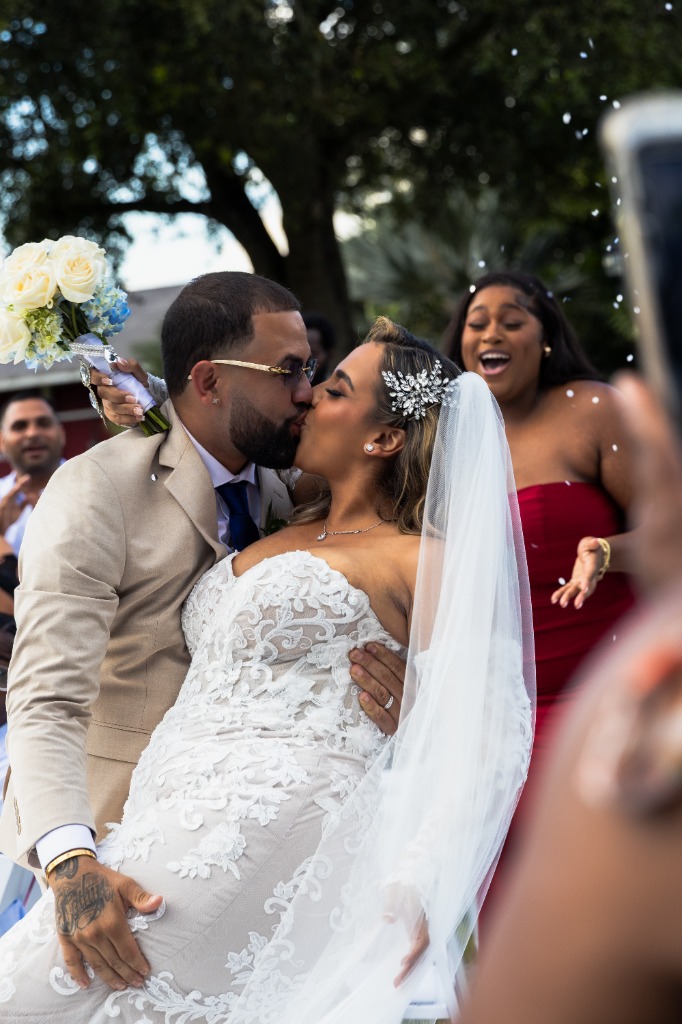 Romantic wedding kiss, bride and groom celebrate throwing confetti